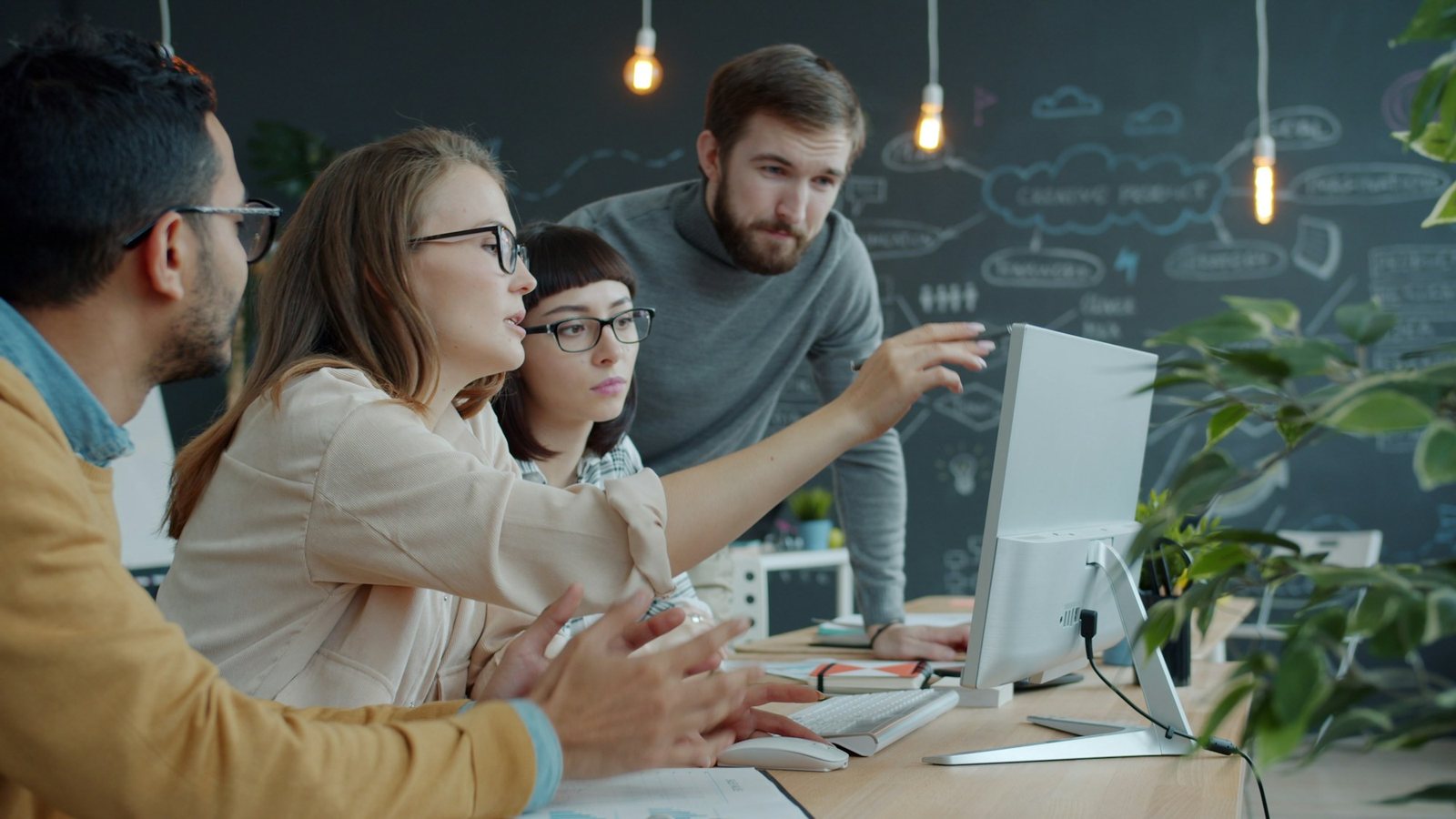 A small team working together around a screen